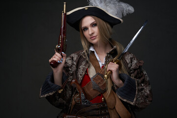 Fototapeta premium Woman buccaneer dressed in pirate suit and hat