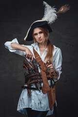 Fototapeta premium Female caribbean sailor with tricorn and pistols