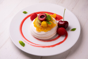 Meringue with assorted fruits. Dessert from a Spanish restaurant.