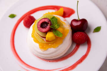 Meringue with assorted fruits. Dessert from a Spanish restaurant.