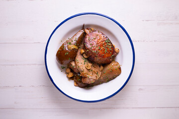 Pork loin cooked with pears and hazelnuts. Traditional Spanish tapa.