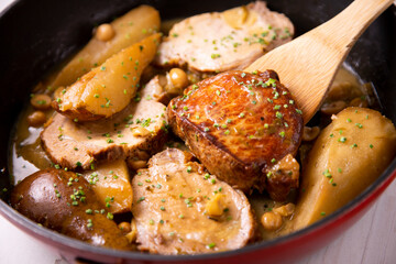 Pork loin cooked with pears and hazelnuts. Traditional Spanish tapa.