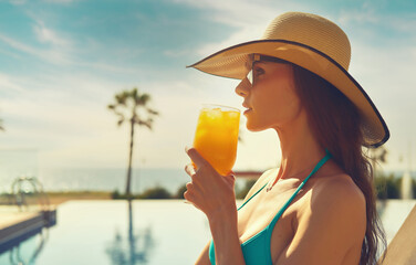 Side profile view face attractive woman, wear straw hat hold glass drinks natural orange juice...