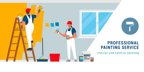 Professional painters painting walls in a residential room © elenabsl