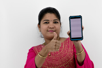Young beautiful woman holding and showing blank screen smartphone or mobile or tablet phone on a white background with empty space available.