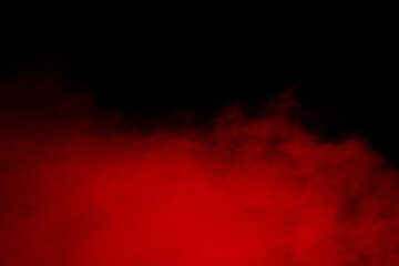 Red powder explosion cloud on black background.