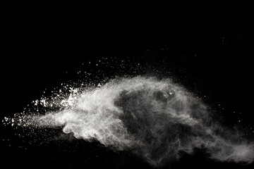 White powder explosion isolated on black background. White dust particles splash.Color Holi Festival.