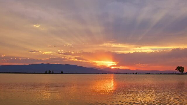 Sunset reflection in Utah Lake during colorful display in scenic view.