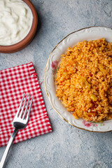 Traditional turkish bulgur pilaf with tomato sause in plate (Turkish name; meyhane pilavi)