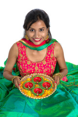 Portrait of a Indian Traditional Girl holding Diya, Girl Celebrating Diwali or Deepavali with...