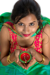 Portrait of a Indian Traditional Girl holding Diya, Girl Celebrating Diwali or Deepavali with...