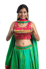Portrait of a Indian Traditional Girl holding Diya, Girl Celebrating Diwali or Deepavali with...