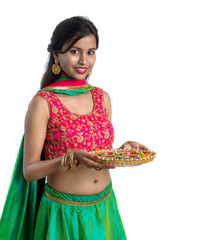 Portrait of a Indian Traditional Girl holding Diya, Girl Celebrating Diwali or Deepavali with...