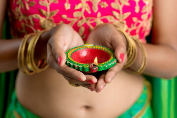 Portrait of a Indian Traditional Girl holding Diya, Girl Celebrating Diwali or Deepavali with...
