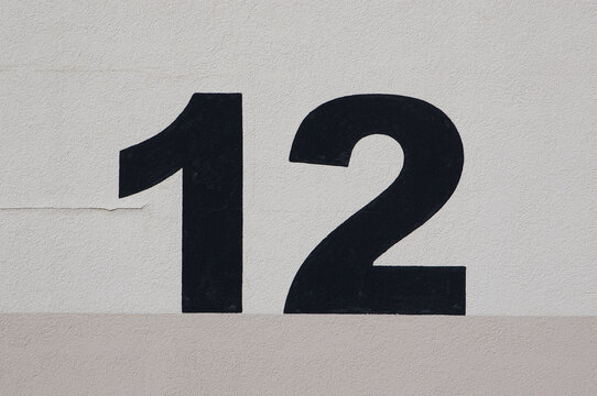 House number "12" painted on a wall