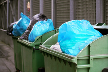 Closeup shot of garbage containers full of trash