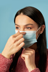Beautiful brunette wearing a protective face mask