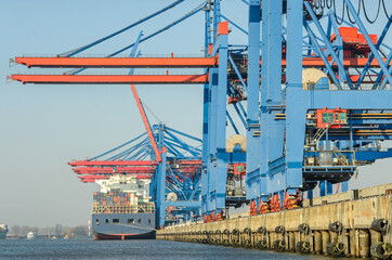 Harbour facilities, container terminal and large container vessel in Hamburg, Germany