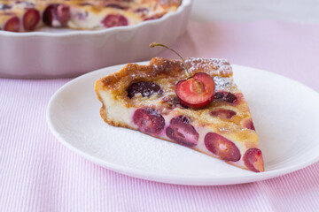 Slice of cherry clafoutis on plate