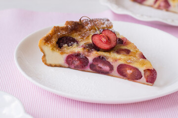 Slice of cherry clafoutis on plate
