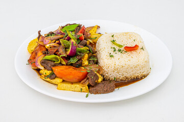 Tray of beef tenderloin sautéed with peppers, tomato, onion, chives and parsley cooked with Peruvian recipe with white rice, french fries and vegetables sauteed with soy sauce