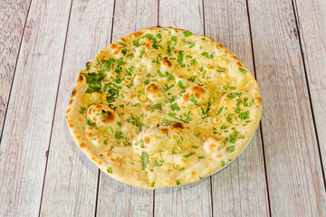 Garlic bread wafer cooked with Indian naan recipe with lots of parsley and garlic