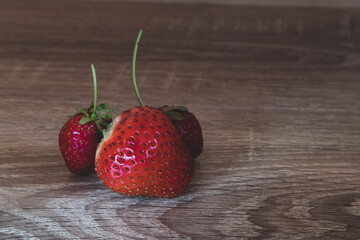 Homemade ripe strawberries on wooden background
