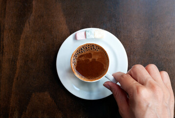 Turkish coffee, while the lady is drinking coffee. 