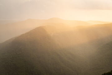 Golden Hour Sunlight over Rain Storm in Gorge in South Carolina Blue Ridge Mountains
