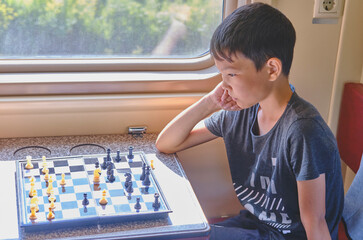 Young boy playing chess