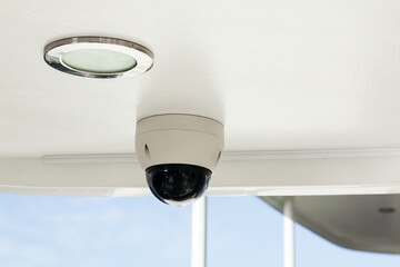 A CCTV camera mounted on the ceiling of a luxury yacht.