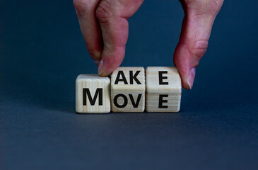 Make your move symbol. Businessman turns wooden cubes with words 'Make move'. Beautiful grey background. Make your move and business concept. Copy space.