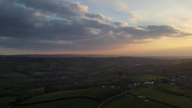 Sunset in the devon countryside far reaching views across the rolling hills in spring