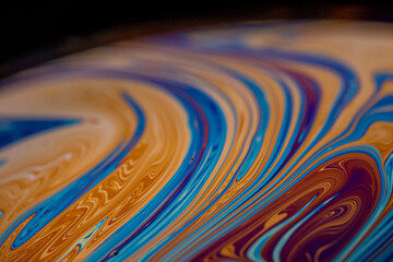 Macro picture of half soap bubble psychedelic color on black background
