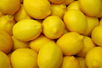 Heap of fresh ripe vivid yellow lemons for background or banner