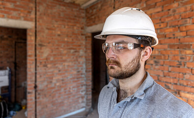 Portrait of a male builder at a construction site.