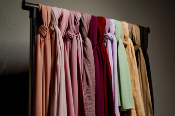 Obraz premium Silk scarf muslim. Multi-colored plain scarves on hanger.