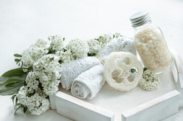 Spa composition with bath accessories and fresh flowers.