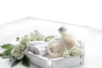 Spa composition with bath accessories and fresh flowers.