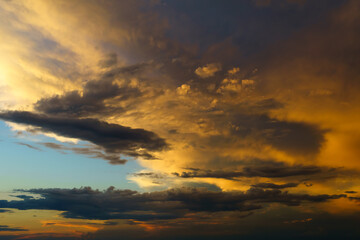 beautiful sunset sky, bright sunlight and silhouette of clouds as a background