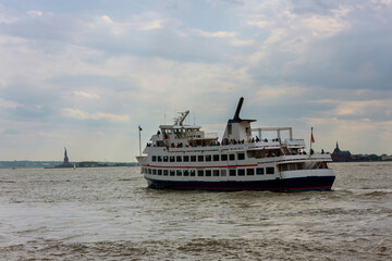 Panoramic view on yacht transporting passengers on Hudson river New York near Statue of Liberty
