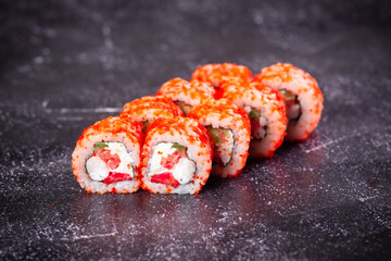 Traditional delicious fresh sushi roll set on a marble background . Sushi roll with rice, cream cheese, avocado, salmon, sesame. Philadelphia. Sushi menu. Japanese kitchen, restaurant.