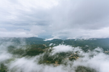 A view of Fluffy clouds and Mountains on a cold tropical morning.