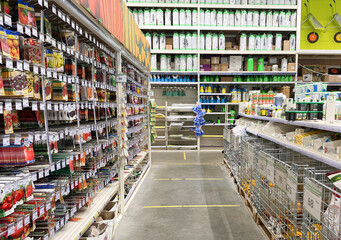 Seed and fertilizer shop. Racks with packaging seeds and fertilizers. Planting season