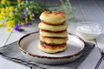 Fototapeta na wymiar Sweet breakfast: cottage cheese pancakes with ricotta stacked on a nice plate.
