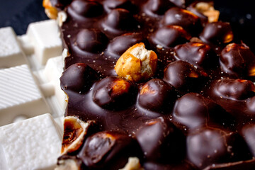 Milk chocolate, white chocolate and black chocolate with nuts