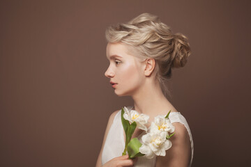 Gentle young beauty. Young blonde woman with white flowers on brown banner background