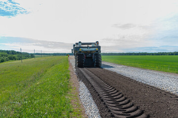 Fototapeta premium We are laying asphalt (we will lay a new road) outside the city in the village.