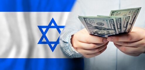 Israel politics, business and social problems concept. US dollars banknotes in hand on Jewish flag background