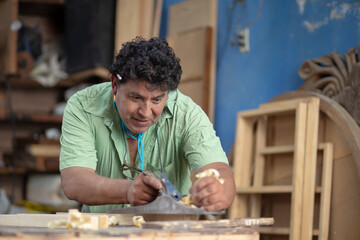 Mexican carpenter working in his workshop